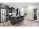 Modern kitchen features a granite island with barstool seating, stainless steel appliances, and gray cabinetry at 18607 Mainsail Ct, Lancaster, SC 29720