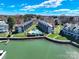 Aerial of lakeside condos with a community pool nestled between the buildings and waterfront access at 18877 Vineyard Point Ln, Cornelius, NC 28031