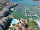 Stunning aerial view of waterfront condos, a marina filled with boats, and a sparkling community pool at 18877 Vineyard Point Ln, Cornelius, NC 28031