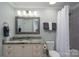 Charming bathroom with framed mirror and vanity with a granite countertop at 18877 Vineyard Point Ln, Cornelius, NC 28031