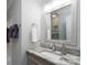 Bright bathroom vanity featuring granite countertops and a decorative mirror at 18877 Vineyard Point Ln, Cornelius, NC 28031