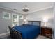 Comfortable bedroom with natural light from windows and fan with lights at 18877 Vineyard Point Ln, Cornelius, NC 28031