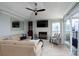 This living room has a fireplace, built in shelves, and a sliding glass door to an outdoor balcony at 18877 Vineyard Point Ln, Cornelius, NC 28031