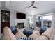 This cozy living room includes a stone fireplace, comfortable seating, and a sliding door to a balcony at 18877 Vineyard Point Ln, Cornelius, NC 28031