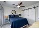 This main bedroom features a ceiling fan, sliding barn doors, and soft natural light at 18877 Vineyard Point Ln, Cornelius, NC 28031