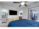 Spacious main bedroom includes an outdoor balcony, ceiling fan, and views to the living room and bathroom at 18877 Vineyard Point Ln, Cornelius, NC 28031