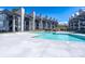 Resort-style pool with clear water and modern condos in the background at 18877 Vineyard Point Ln, Cornelius, NC 28031
