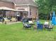 Large backyard featuring a patio, fire pit, swing set and mature trees at 205 Kaitlyn Ln, Kings Mountain, NC 28086