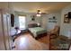 Cozy bedroom featuring hardwood floors, a ceiling fan, and quaint decor elements at 205 Kaitlyn Ln, Kings Mountain, NC 28086