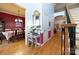 Open foyer with hardwood flooring, stairs, wrought iron railing and dining room view offer inviting, elegant entry at 205 Kaitlyn Ln, Kings Mountain, NC 28086