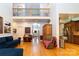 Open-concept living room featuring hardwood floors, a fireplace and a view of the kitchen and foyer at 205 Kaitlyn Ln, Kings Mountain, NC 28086