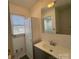 This bathroom has tile floors, a modern vanity, a large mirror, and a storage cabinet at 216 W Shannonhouse St, Shelby, NC 28152