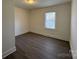 Bright bedroom features modern vinyl flooring and a window letting in plenty of natural light at 216 W Shannonhouse St, Shelby, NC 28152