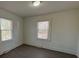 This bright bedroom is freshly painted and features two windows with wood-look vinyl flooring at 216 W Shannonhouse St, Shelby, NC 28152