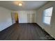 This bedroom features wood-look vinyl flooring, fresh paint, and a window at 216 W Shannonhouse St, Shelby, NC 28152