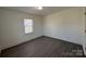 Bright bedroom features modern vinyl flooring and a window letting in plenty of natural light at 216 W Shannonhouse St, Shelby, NC 28152
