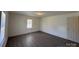 This bedroom features wood-look vinyl flooring, fresh paint, and double closets at 216 W Shannonhouse St, Shelby, NC 28152