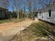 Exterior of home showcasing the side yard, siding, and driveway leading towards the back at 216 W Shannonhouse St, Shelby, NC 28152