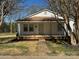 Charming white home with a covered porch, offering a welcoming curb appeal with neat landscaping at 216 W Shannonhouse St, Shelby, NC 28152