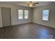 Inviting living room with wood-look floors, neutral walls, and ample natural light from the windows at 216 W Shannonhouse St, Shelby, NC 28152