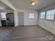 Bright living space features new flooring and convenient access to the updated kitchen at 216 W Shannonhouse St, Shelby, NC 28152