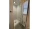 This stand-up shower features glass doors and tile floors with a window for natural light at 216 W Shannonhouse St, Shelby, NC 28152