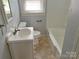 The bathroom features a white vanity, tile floors, and a shower/tub combo at 220 Valleyview Pl, Salisbury, NC 28144