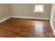 The bedroom boasts hardwood floors, natural light, and neutral paint at 220 Valleyview Pl, Salisbury, NC 28144