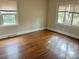 Bright bedroom featuring hardwood floors, two windows and neutral colored walls at 220 Valleyview Pl, Salisbury, NC 28144