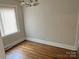 The dining room has a chandelier, hardwood floors and natural light from the window at 220 Valleyview Pl, Salisbury, NC 28144