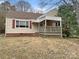 Charming one-story home with tan siding, brown shutters, a covered porch, and a well-kept lawn at 220 Valleyview Pl, Salisbury, NC 28144