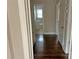 Hallway with hardwood floors and a view to a bathroom at the end of the hall at 220 Valleyview Pl, Salisbury, NC 28144