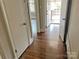 Hallway with hardwood floors leading to multiple rooms and a covered porch at 220 Valleyview Pl, Salisbury, NC 28144