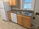 Functional kitchen with light wood cabinets and a stainless steel double basin sink at 220 Valleyview Pl, Salisbury, NC 28144