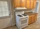 Bright kitchen features a white gas range, wooden cabinets and updated countertops at 220 Valleyview Pl, Salisbury, NC 28144