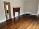 Spacious living room showcasing hardwood floors, brick fireplace and neutral paint at 220 Valleyview Pl, Salisbury, NC 28144