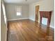 Bright living room with hardwood flooring and a red brick fireplace feature at 220 Valleyview Pl, Salisbury, NC 28144