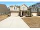 Charming two-story home featuring a brick facade, covered porch, and a well-maintained front yard at 2236 Sussex Rd, York, SC 29745