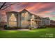 This backyard has lush green grass and a beautiful covered patio for outdoor living at 2300 Bonnie Butler Way, Charlotte, NC 28270