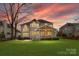 This beautiful home has a large backyard with lush green grass and a covered patio at 2300 Bonnie Butler Way, Charlotte, NC 28270