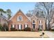 Traditional brick home with mature trees and an expansive front yard at 2300 Bonnie Butler Way, Charlotte, NC 28270