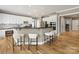 Modern kitchen with white cabinets, stainless steel appliances, and breakfast bar at 2300 Bonnie Butler Way, Charlotte, NC 28270