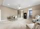 This living room features neutral walls and carpet with a table and sitting area at 2300 Bonnie Butler Way, Charlotte, NC 28270