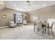 This living room has neutral walls and carpet and features a table and sitting area at 2300 Bonnie Butler Way, Charlotte, NC 28270