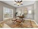 A window provides natural light to the home office with a desk and hardwood floors at 2300 Bonnie Butler Way, Charlotte, NC 28270