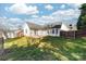 Spacious backyard featuring a grassy lawn, patio, privacy fence, and mature trees at 2359 Eagle Glen Ct, Gastonia, NC 28056