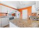Well-lit kitchen featuring granite countertops, white appliances, and ample counter space at 2359 Eagle Glen Ct, Gastonia, NC 28056