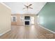 A large living room with a fireplace, natural light, and wood flooring at 2359 Eagle Glen Ct, Gastonia, NC 28056