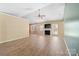 Bright living room featuring a fireplace, ceiling fan, and modern flooring with access to the exterior at 2359 Eagle Glen Ct, Gastonia, NC 28056