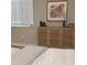 Comfortable bedroom featuring a unique wooden cabinet with a decorative pattern and a serene ambiance at 2545 Stockbridge Dr, Charlotte, NC 28210
